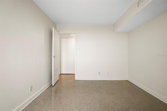 10355 Paradise Blvd Unit 1003, Treasure Island, FL 33706 - spare room with baseboards and speckled floor