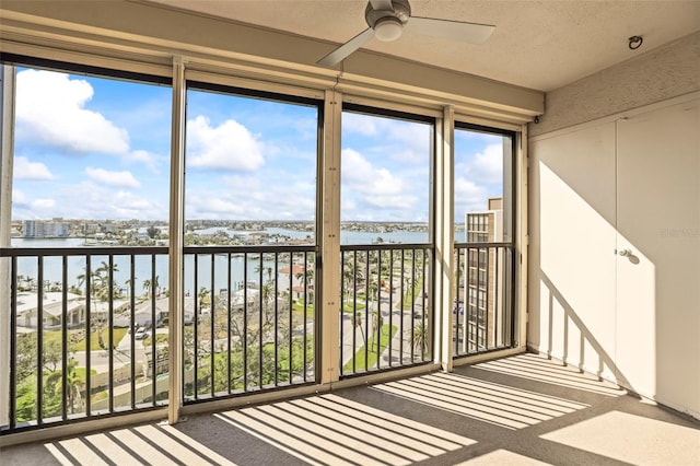 10355 Paradise Blvd Unit 1003, Treasure Island, FL 33706 - unfurnished sunroom with a water view and carpet flooring