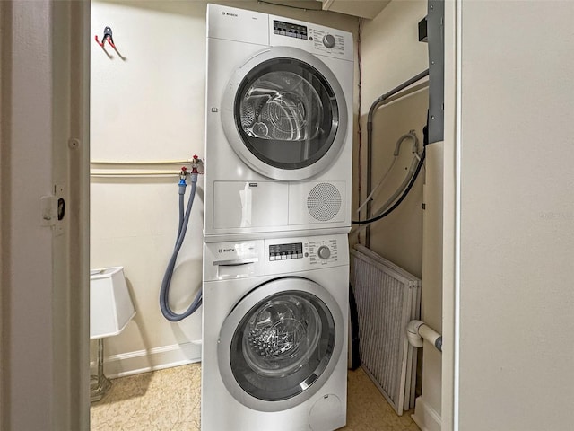 10355 Paradise Blvd Unit 1003, Treasure Island, FL 33706 - laundry room with stacked washer / dryer and baseboards