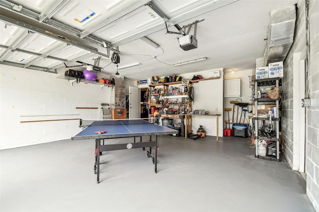 5005 W Evelyn Dr, Tampa, FL 33609 - garage featuring a garage door opener and a workshop area