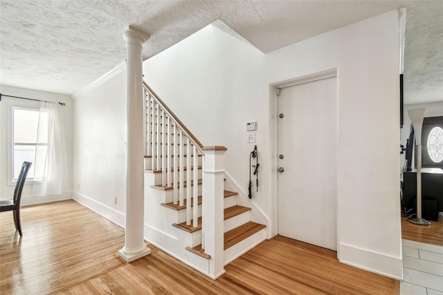 5005 W Evelyn Dr, Tampa, FL 33609 - staircase featuring a textured ceiling, wood finished floors, and baseboards
