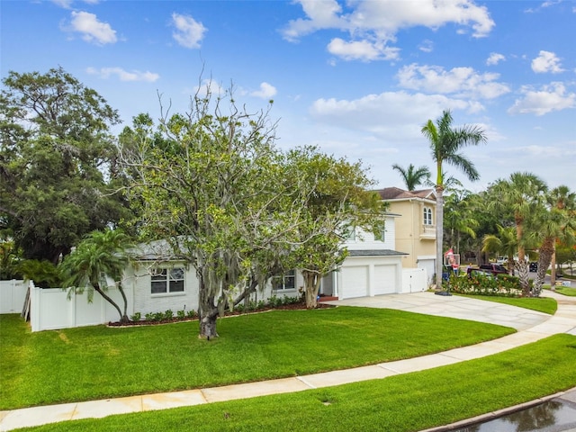 5005 W Evelyn Dr, Tampa, FL 33609 - view of property hidden behind natural elements featuring a garage and concrete driveway
