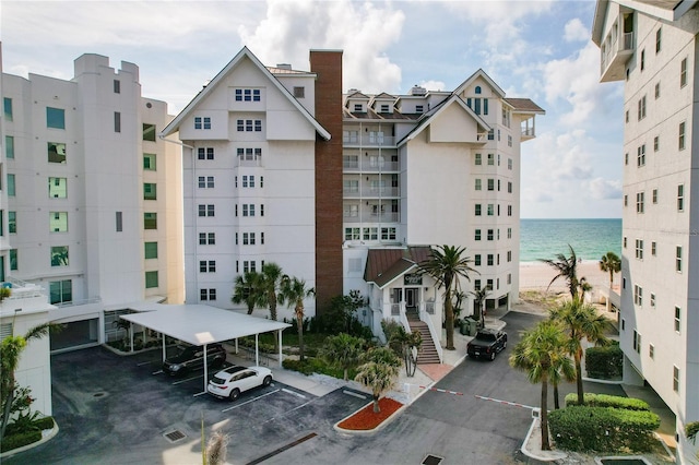 1586 Gulf Blvd Unit 2502, Clearwater, FL 33767 - view of property featuring covered and uncovered parking and a water view