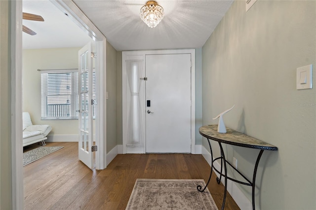 1586 Gulf Blvd Unit 2502, Clearwater, FL 33767 - entryway with wood finished floors, baseboards, and a chandelier