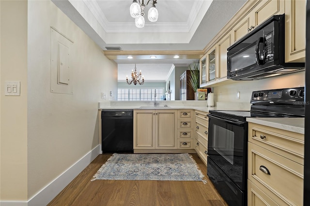 1586 Gulf Blvd Unit 2502, Clearwater, FL 33767 - kitchen with black appliances, a chandelier, crown molding, cream cabinetry, and dark wood finished floors