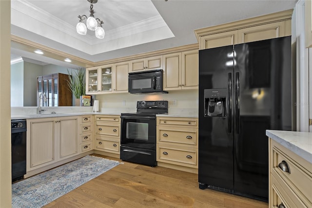 1586 Gulf Blvd Unit 2502, Clearwater, FL 33767 - kitchen featuring black appliances, a sink, cream cabinets, crown molding, and light countertops