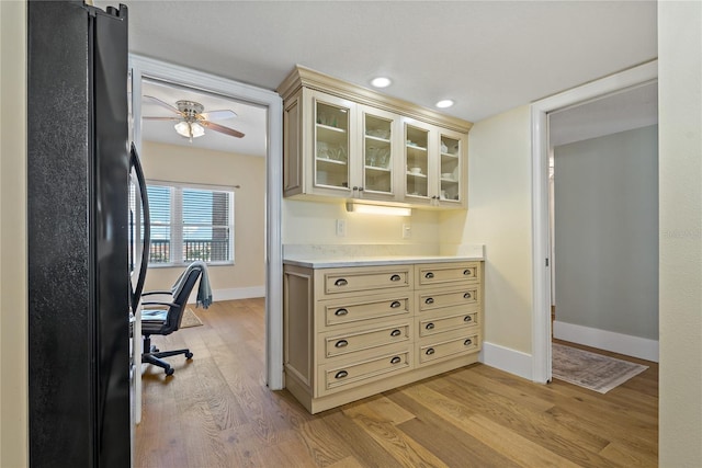 1586 Gulf Blvd Unit 2502, Clearwater, FL 33767 - kitchen with freestanding refrigerator, cream cabinetry, light countertops, light wood finished floors, and recessed lighting