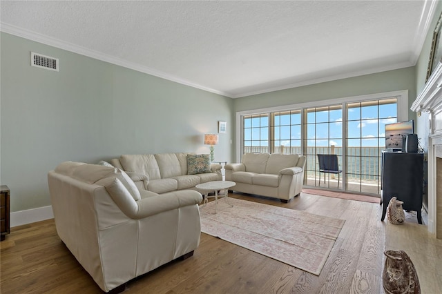 1586 Gulf Blvd Unit 2502, Clearwater, FL 33767 - living room featuring crown molding, wood finished floors, a textured ceiling, and baseboards