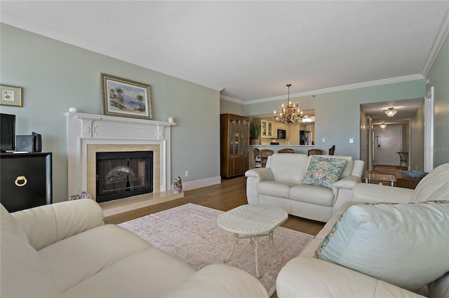 1586 Gulf Blvd Unit 2502, Clearwater, FL 33767 - living room with a chandelier, crown molding, wood finished floors, a fireplace, and baseboards