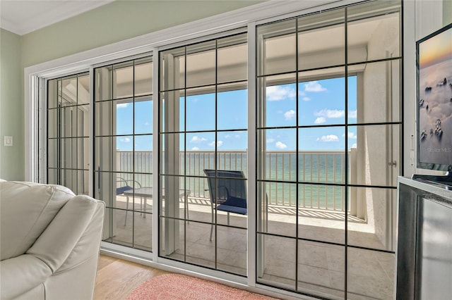 1586 Gulf Blvd Unit 2502, Clearwater, FL 33767 - doorway to outside featuring light wood-style flooring, ornamental molding, and healthy amount of natural light