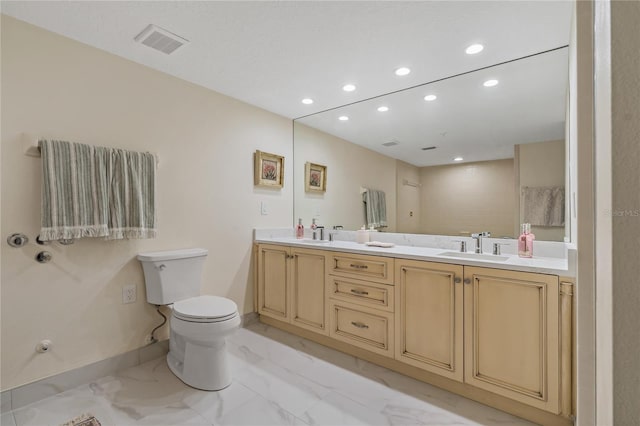 1586 Gulf Blvd Unit 2502, Clearwater, FL 33767 - bathroom featuring recessed lighting, double vanity, marble finish flooring, toilet, and baseboards