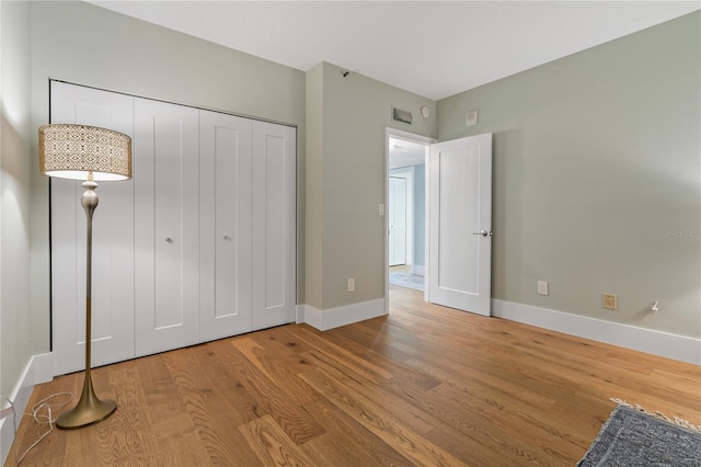 1586 Gulf Blvd Unit 2502, Clearwater, FL 33767 - unfurnished bedroom featuring wood finished floors, baseboards, and a closet