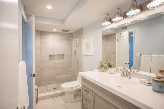 5701 Bahia Del Mar Cir Unit 108, Saint Petersburg, FL 33715 - bathroom with toilet, vanity, a tile shower, tile patterned floors, and recessed lighting