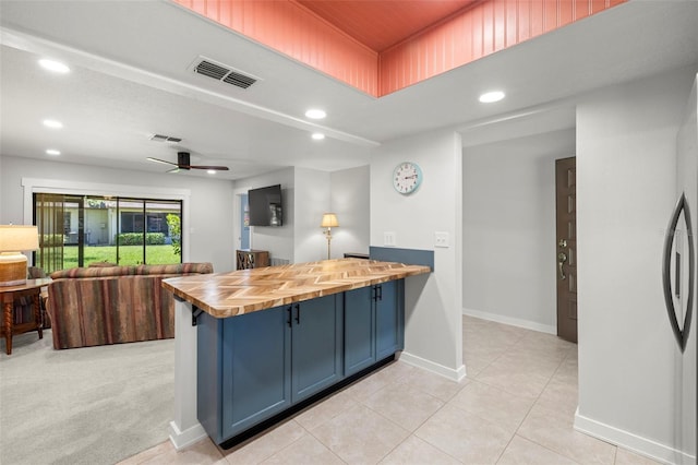 2510 Laurelwood Dr Unit 5B, Clearwater, FL 33763 - kitchen with wood counters, blue cabinets, open floor plan, recessed lighting, and a peninsula