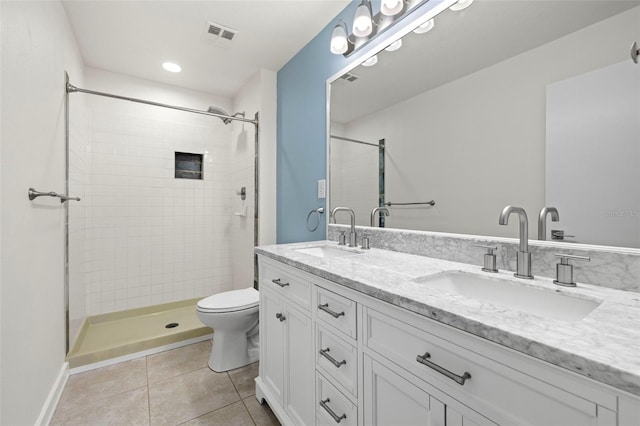 2510 Laurelwood Dr Unit 5B, Clearwater, FL 33763 - bathroom with tile patterned floors, double vanity, toilet, tiled shower, and recessed lighting
