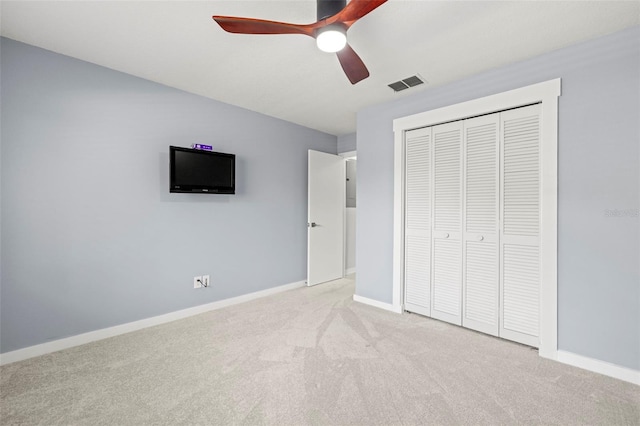2510 Laurelwood Dr Unit 5B, Clearwater, FL 33763 - unfurnished bedroom featuring carpet, a closet, baseboards, and a ceiling fan