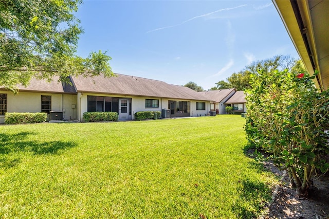 2510 Laurelwood Dr Unit 5B, Clearwater, FL 33763 - back of house featuring a yard, cooling unit, and stucco siding