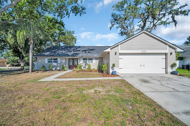 3202 Cullendale Dr, Tampa, FL 33618 - ranch-style home with an attached garage, concrete driveway, stucco siding, and cooling unit