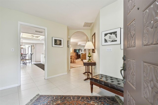 3476 Tarpon Woods Blvd, Palm Harbor, FL 34685 - foyer with arched walkways, light tile patterned floors, and baseboards