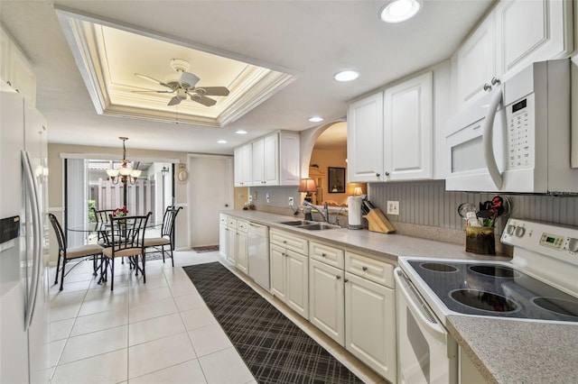 3476 Tarpon Woods Blvd, Palm Harbor, FL 34685 - kitchen featuring white appliances, a raised ceiling, a sink, arched walkways, and a ceiling fan