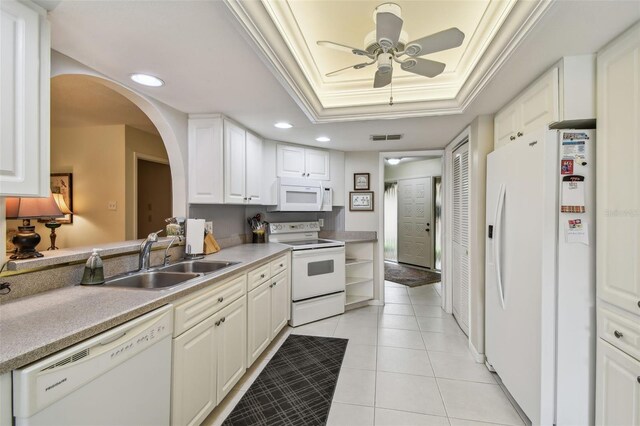 3476 Tarpon Woods Blvd, Palm Harbor, FL 34685 - kitchen with white appliances, a sink, a raised ceiling, ceiling fan, and arched walkways