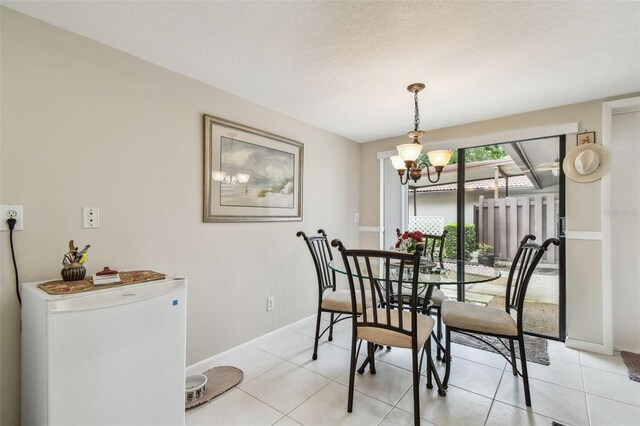 3476 Tarpon Woods Blvd, Palm Harbor, FL 34685 - dining space with a chandelier, light tile patterned flooring, and baseboards