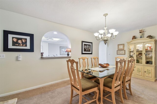 3476 Tarpon Woods Blvd, Palm Harbor, FL 34685 - dining room with light carpet, a chandelier, arched walkways, and baseboards