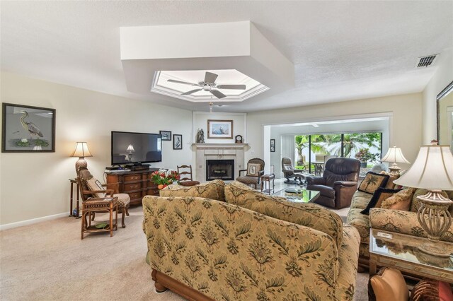 3476 Tarpon Woods Blvd, Palm Harbor, FL 34685 - living area featuring a skylight, a fireplace, light carpet, baseboards, and ceiling fan