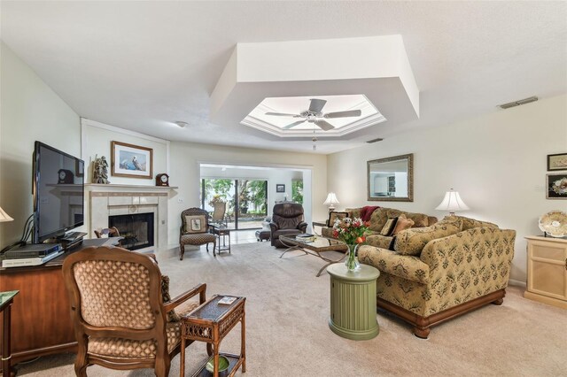 3476 Tarpon Woods Blvd, Palm Harbor, FL 34685 - living area with light colored carpet, a fireplace, a skylight, and a ceiling fan