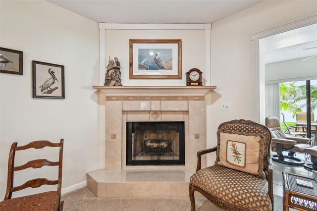 3476 Tarpon Woods Blvd, Palm Harbor, FL 34685 - sitting room with carpet flooring and a tiled fireplace