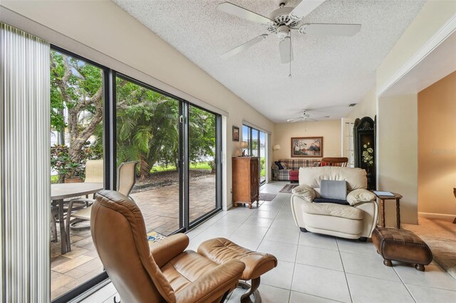 3476 Tarpon Woods Blvd, Palm Harbor, FL 34685 - living room featuring ceiling fan, a textured ceiling, and light tile patterned floors