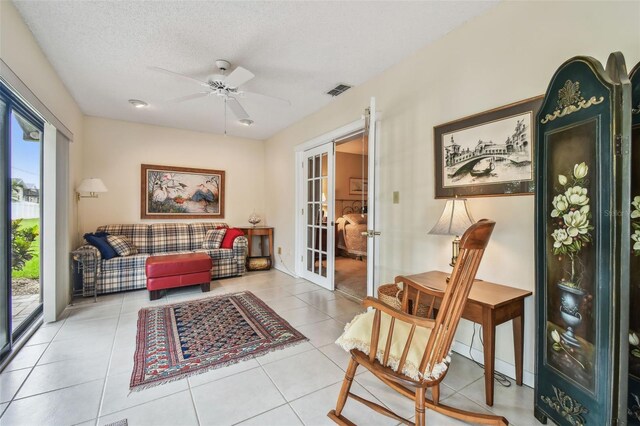 3476 Tarpon Woods Blvd, Palm Harbor, FL 34685 - living area featuring a ceiling fan, french doors, tile patterned floors, and a textured ceiling