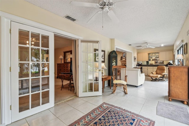 3476 Tarpon Woods Blvd, Palm Harbor, FL 34685 - interior space with a ceiling fan, french doors, light tile patterned floors, and a textured ceiling