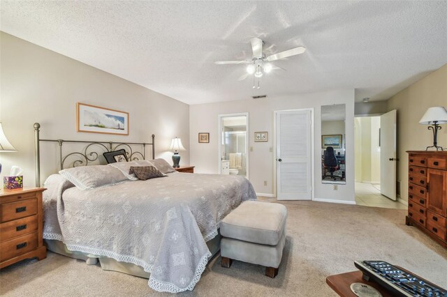 3476 Tarpon Woods Blvd, Palm Harbor, FL 34685 - bedroom with light colored carpet, connected bathroom, a textured ceiling, a closet, and a ceiling fan