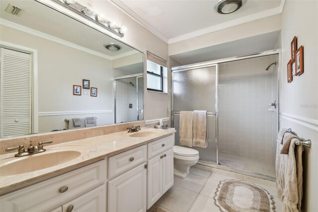 3476 Tarpon Woods Blvd, Palm Harbor, FL 34685 - bathroom with double vanity, toilet, a shower stall, tile patterned flooring, and ornamental molding
