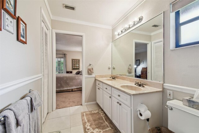 3476 Tarpon Woods Blvd, Palm Harbor, FL 34685 - full bath featuring ensuite bathroom, double vanity, toilet, tile patterned flooring, and ornamental molding