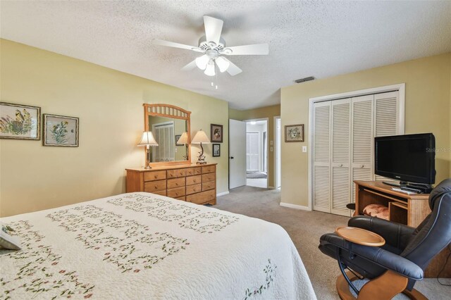 3476 Tarpon Woods Blvd, Palm Harbor, FL 34685 - bedroom featuring a closet, carpet, a textured ceiling, ceiling fan, and baseboards