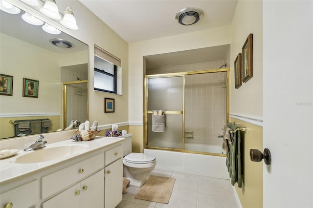 3476 Tarpon Woods Blvd, Palm Harbor, FL 34685 - full bathroom with tile patterned floors, toilet, vanity, and bath / shower combo with glass door