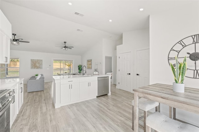 10538 Juliano Dr, Riverview, FL 33569 - kitchen featuring stainless steel appliances, a sink, open floor plan, white cabinetry, and light countertops