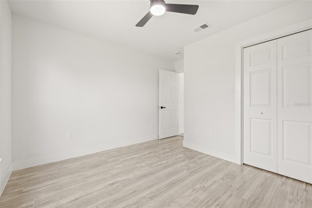 10538 Juliano Dr, Riverview, FL 33569 - unfurnished bedroom with light wood-type flooring, a closet, ceiling fan, and baseboards