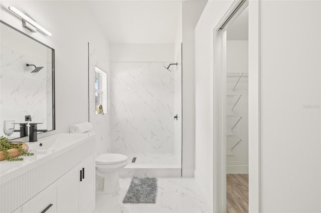 10538 Juliano Dr, Riverview, FL 33569 - bathroom featuring a marble finish shower, vanity, toilet, and a walk in closet