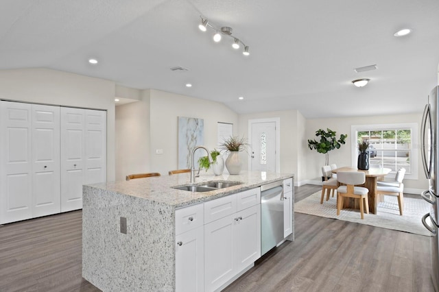 4121 W San Nicholas St, Tampa, FL 33629 - kitchen with appliances with stainless steel finishes, wood finished floors, a sink, a center island with sink, and white cabinetry