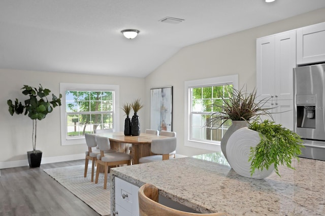 4121 W San Nicholas St, Tampa, FL 33629 - dining space featuring healthy amount of natural light, lofted ceiling, wood finished floors, and baseboards