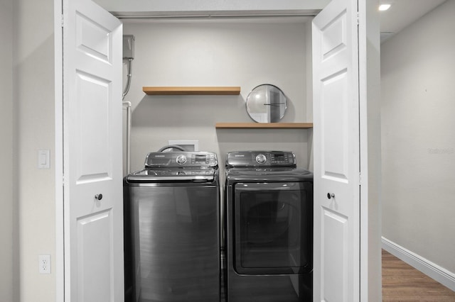 4121 W San Nicholas St, Tampa, FL 33629 - laundry room featuring washing machine and dryer, wood finished floors, and baseboards