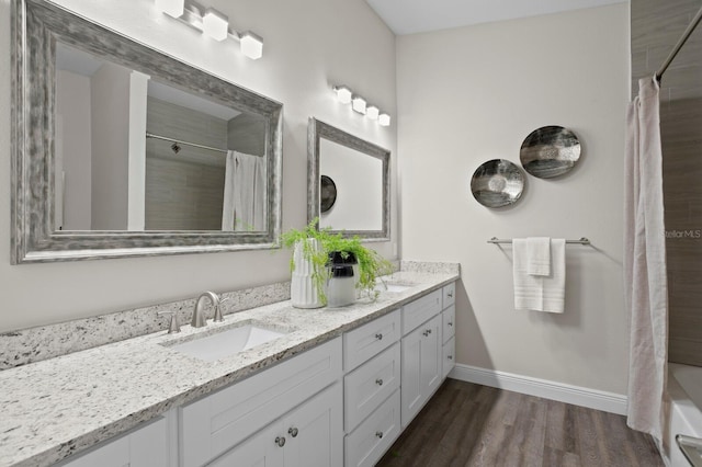 4121 W San Nicholas St, Tampa, FL 33629 - full bath featuring wood finished floors, baseboards, and double vanity