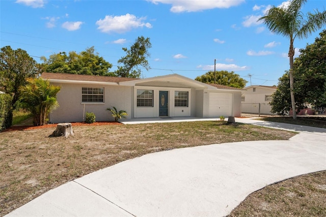 5122 Chet Dr, New Port Richey, FL 34652 - ranch-style home with an attached garage, concrete driveway, stucco siding, and a porch