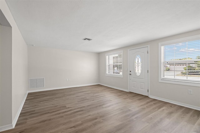 5122 Chet Dr, New Port Richey, FL 34652 - foyer entrance featuring wood finished floors and baseboards