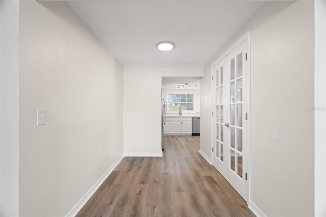 5122 Chet Dr, New Port Richey, FL 34652 - hall featuring wood finished floors, baseboards, and french doors
