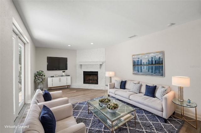 5122 Chet Dr, New Port Richey, FL 34652 - living room with wood finished floors, a fireplace, recessed lighting, and baseboards