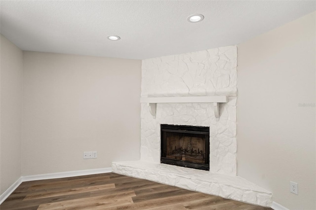 5122 Chet Dr, New Port Richey, FL 34652 - unfurnished living room featuring a fireplace, baseboards, wood finished floors, and recessed lighting